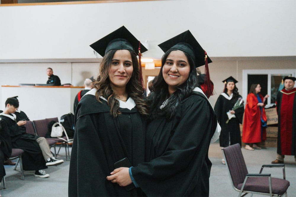 grads-1000 Two female smiling grads at Providence