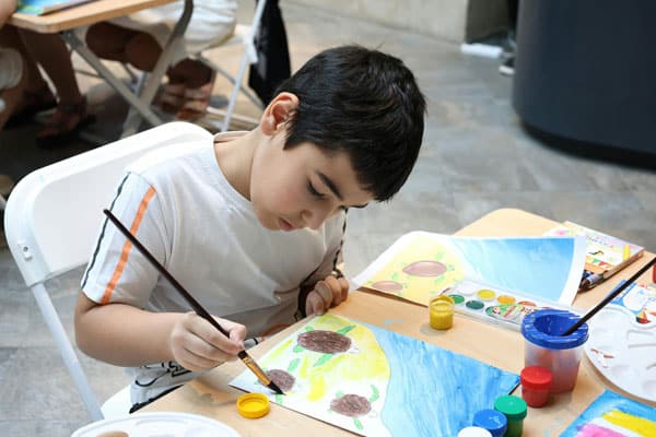 Young boy engaged in a creative art activity.